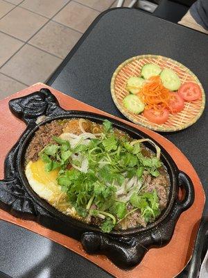 Bo Ne (Sizzling steak and eggs with pate, xiu mai [Vietnamese meatballs], onions, and cilantro) // ig: @sandyeatslocal