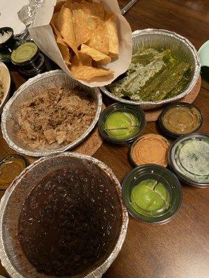 Family Meal deal! Great deal for takeout. Chips, yucca, black beans, carnitas (you get 2 of those containers of meat) & all the fixings.