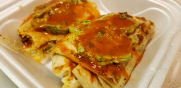 Hot sauce and guacamole topped Al pastor burrito