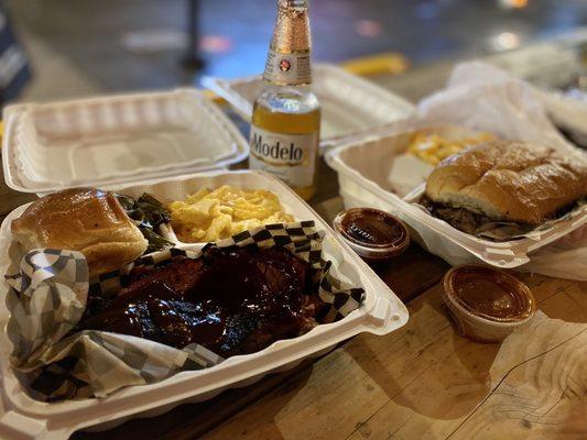 Tritip and pulled pork sandwich with greens and Mac n cheese