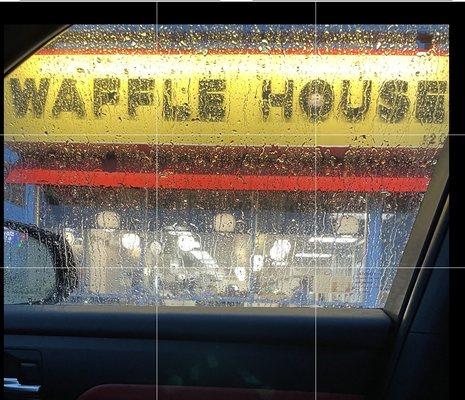 Waffle House #131 through vehicle window in the rain