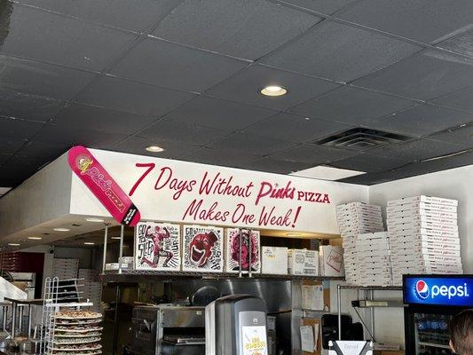 Front counter of the shop with two registers and several menus at the counter