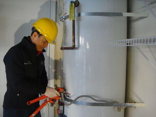 John Im works on water heater installation