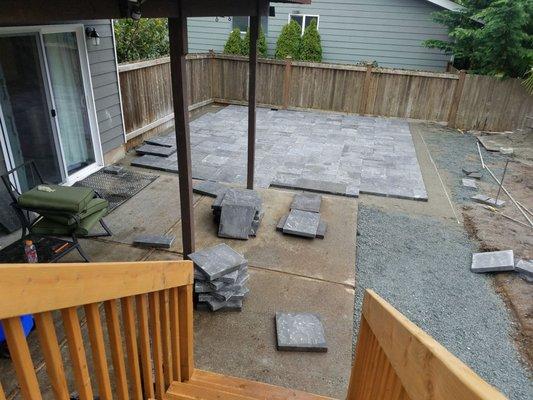 Patio extension in progress.  various sized paving stones and brick edging.  clean edges and nice  transition with our existing concrete pad