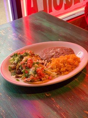 Pollo, carne asada, and pastor tacos with rice and beans