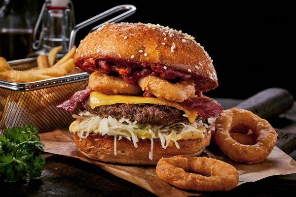 San Francisco Burger with Applewood-Smoked Bacon, Cheddar Cheese, Crispy Onion Rings, Barbeque Sauce, and Chipotle Aioli.