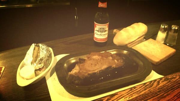 Prime rib with baked potato and Budweiser