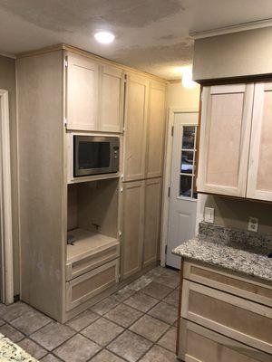 Custom pantry with pullout drawers, microwave and oven space.