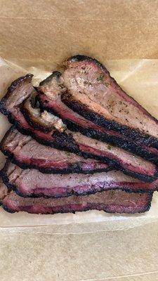 Smoked brisket with herb oil.‍