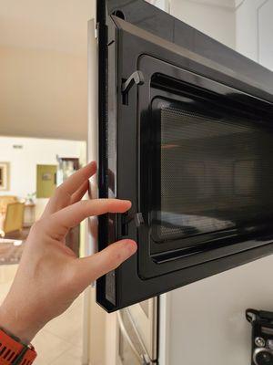 Microwave door hooks won't go up and down.