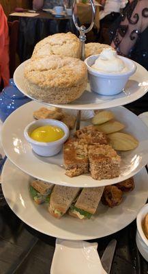 Tea service (four sandwhich types, four desserts, and a scone per person!). With delicious clotted cream and lemon curd.