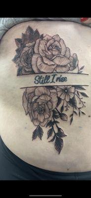 Floral rib cage piece ("Still I rise" text done at another shop)