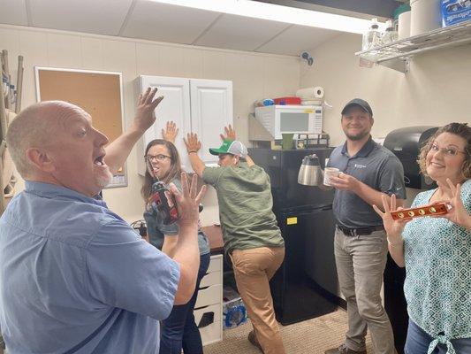 How many office people does it take to hang a shelf?