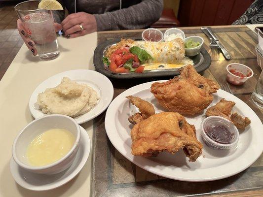 Fried chicken dinner with mashed potatoes.