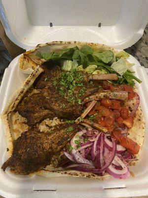 Lamb chop, bowl, tomatoes, lettuce, onions, bread, and lamb chops along with rice pilaf, very tasty!!