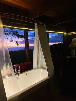 Bathtub in room with panoramic ocean views. Wall to wall Windows fitted with screens