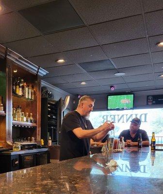 This bartender needs help, he's very overwhelmed.