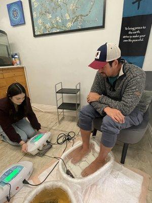 Ms. Miranda assisting with the detox foot-baths.