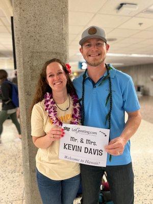 A picture of us with our leis and welcome sign.