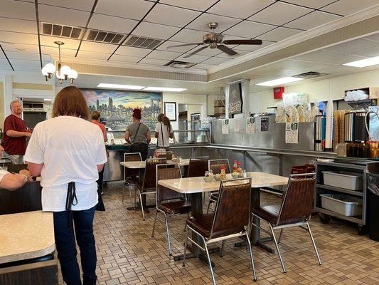 Cafeteria serving line just as the place opens for the day. The steam table features several meats and about a dozen sides on any given day.