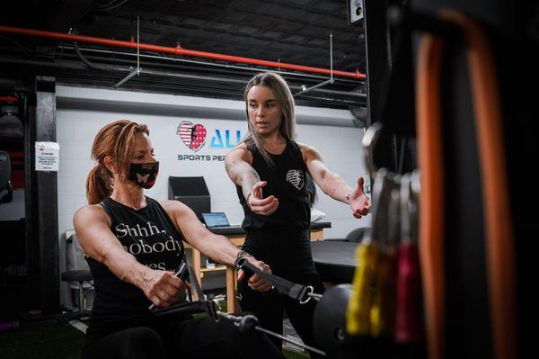 Kristin, PTA demonstrating proper posture for seated rows