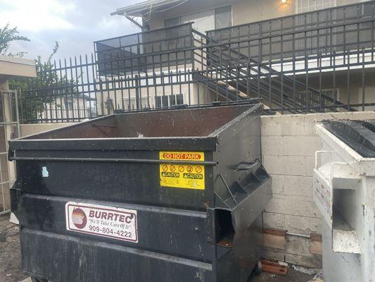 Trash cans full of maggots ( no working gate so everyone has access to trash cans )