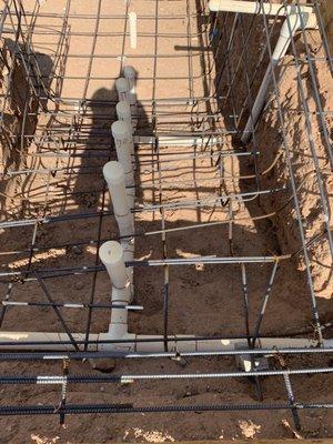 Bent rusted rebar on stairs, pieces of rebar missing and sitting at bottom of pool with rusted metal ties