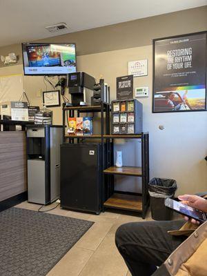 The waiting area with a water and coffee station.