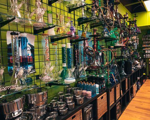 A diverse collection of glass waterpipes, hookahs and storage solutions.