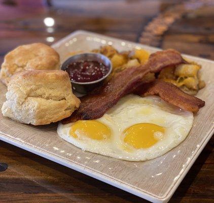 Traditional breakfast with eggs, bacon, house made buttermilk biscuits and skillet potatoes