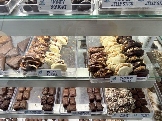 Gourmet chocolates in glass cases.