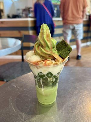 Meccha 8 parfait with soft serve, red bean, matcha jelly, whipped cream, waffle crackers, mochi balls, strawberry sauce, and matcha cake