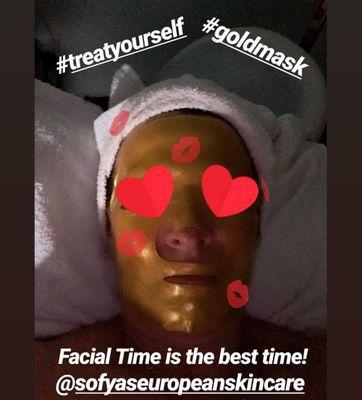 Our client enjoying a gold mask with a customized facial by Sofya