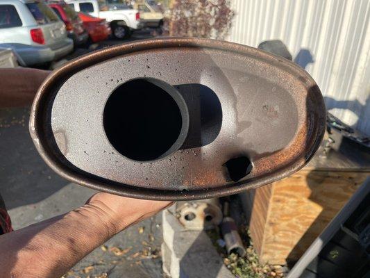 My muffler resonator with a hole that certainly should not have been there.