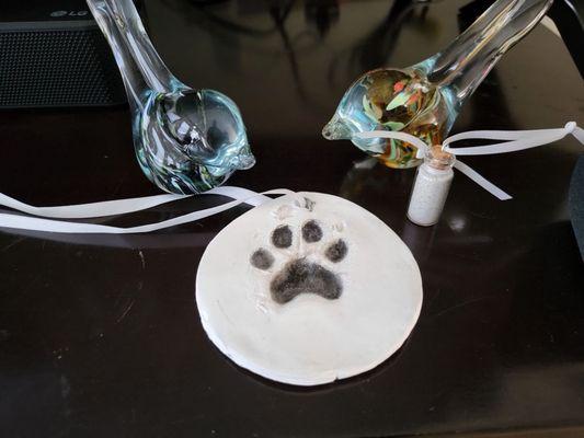 Clay paw print and vile.