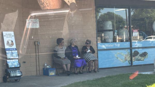 Cute lady's Just chatting by the dry cleaners and donut shop.