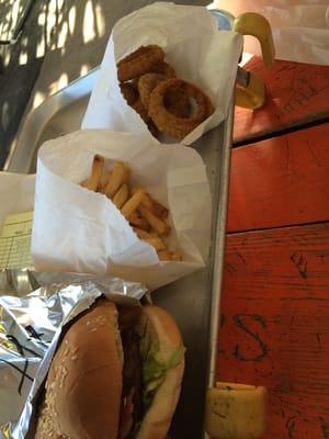 Bacon cheeseburger, fries and onion rings.