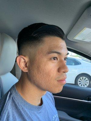 Medium skin fade with scissor trim on top