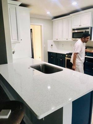 After- Gray Owl on the walls, White Upper Cabinets, Navy Bottom Cabinets, White Backsplash.