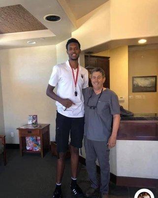 Dr. Curley with his tallest patient, Evan Mobely.