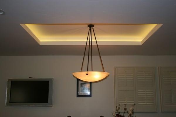 LED Tape light illuminating a cove over a dining room table.