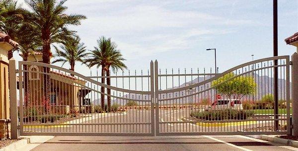 A custom, double entry gate into a new community, arched work double to rail.