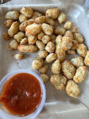 Cheese curds with marinara dipping sauce.