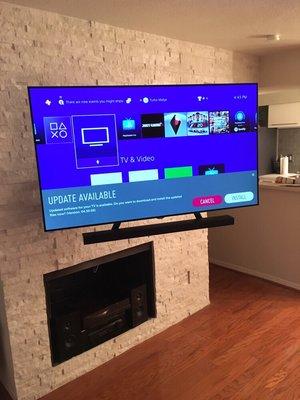 Wall mounted TV and sound bar mounted to TV with concealed cables