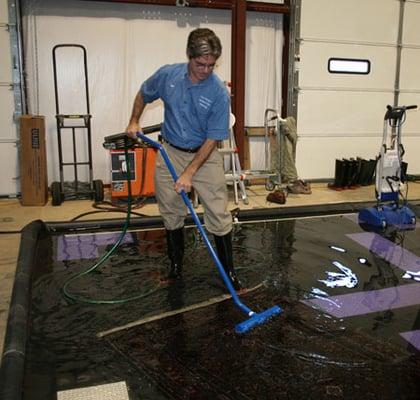 Daniel Traub performing wash (rinse) of Oriental rug