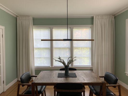 Custom drapes on ceiling track with Hunter Douglas Designer Roller Shades