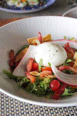 Friśee salad with: soft boiled egg, lardons, warm bacon vinaigrette