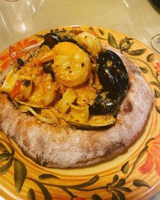 Shellfish in a lobster cream sauce with pasta on a bread bowl (fabulous)