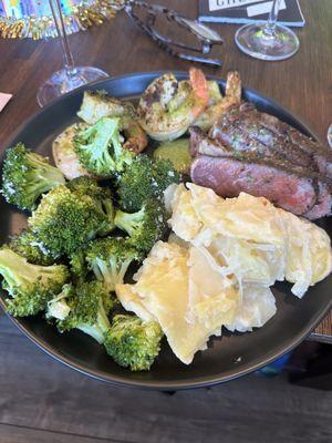 Steak, shrimp, scalloped potatoes with veg. Delicious!