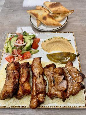 Pork Ribs, rice, salad, hummus and bread.